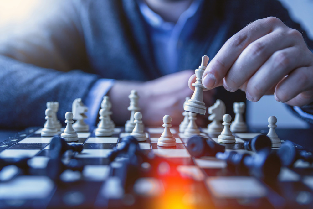 A man playing chess using strategy
